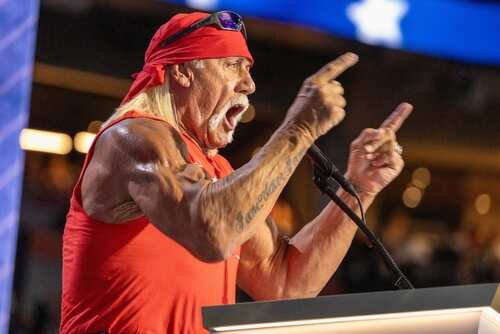 shutterstock_2525067969 (1).jpg A muscular man in a red bandana passionately speaking at a podium