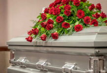 Casket with red roses on top