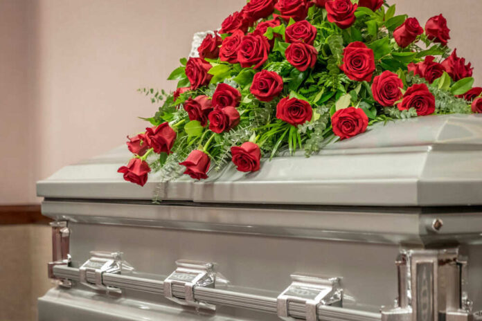 1734828347 Casket with red roses on top