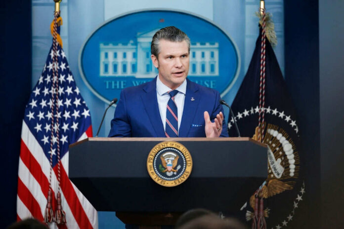 2586172231 Man speaking at podium with US flags behind