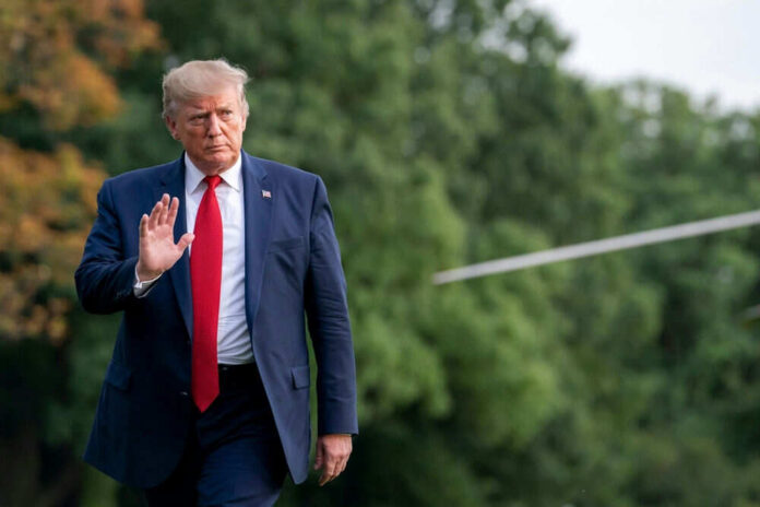 2589906687 Person in suit walking outdoors waving hand