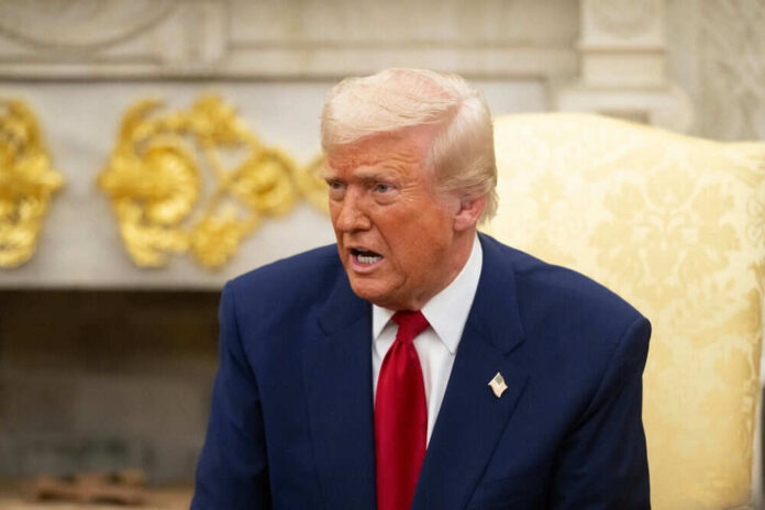 Man in a suit speaking in an ornate room