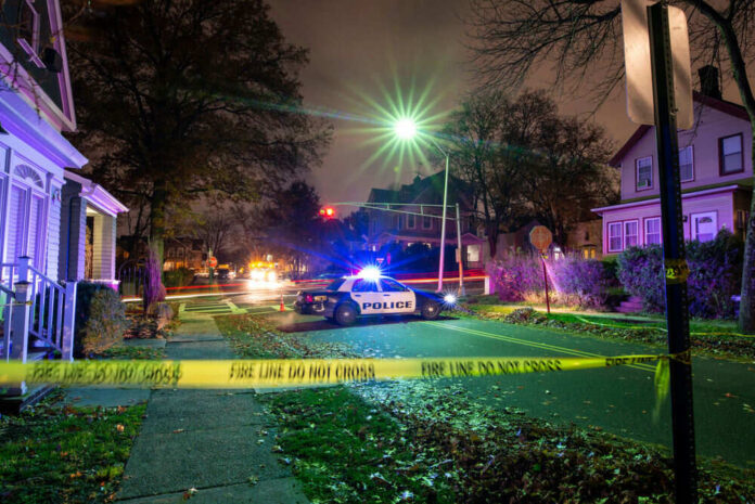 shutterstock_1793905801 Police car at night with caution tape nearby
