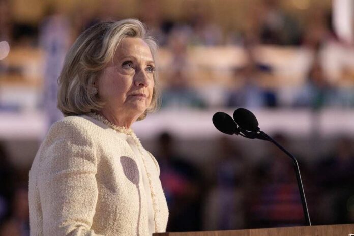 A woman speaking at a podium with a microphone, looking thoughtfully into the distance