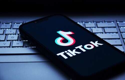 shutterstock_2560084537.jpg Smartphone displaying the TikTok logo on a keyboard