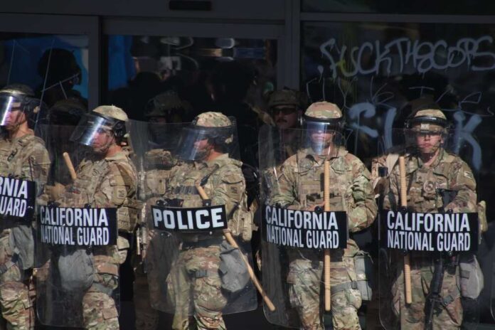 Members of the California National Guard in riot gear standing in formation