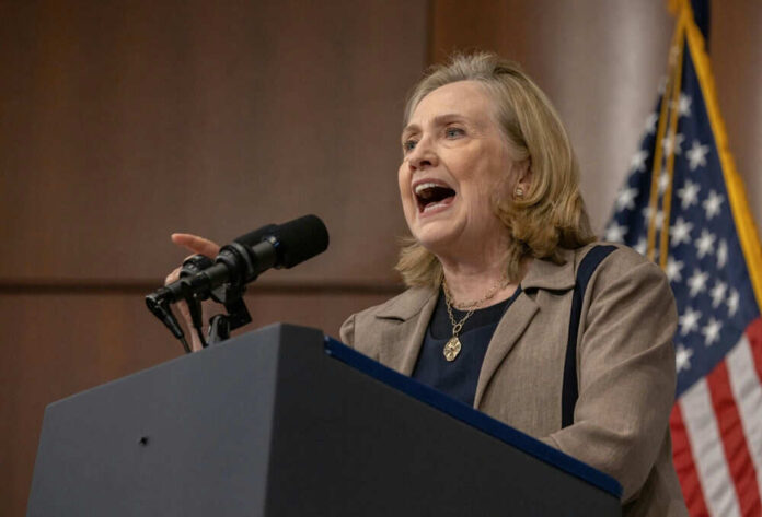 Person speaking at podium with American flag background