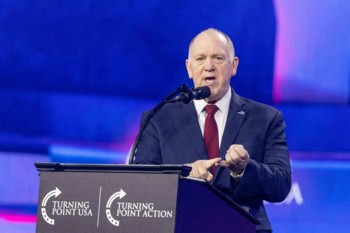 Man speaking at Turning Point USA event podium
