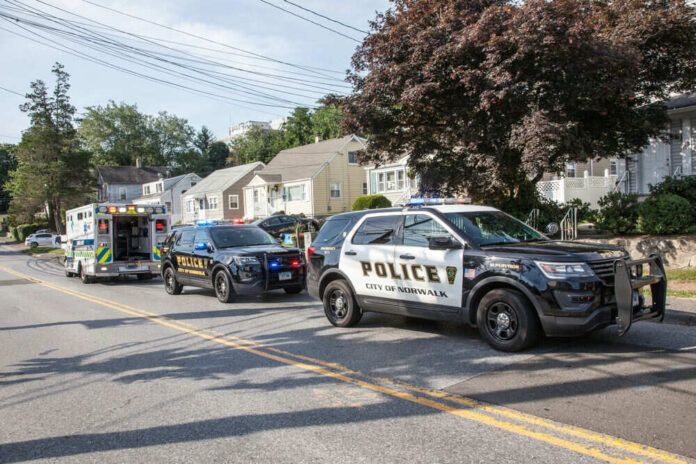 Police and ambulance vehicles parked on street