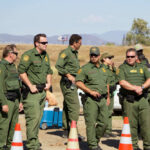 Group of officers standing near traffic cones outside