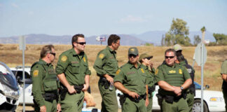Group of officers standing near traffic cones outside