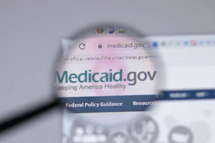 Magnifying glass over Medicaid website homepage
