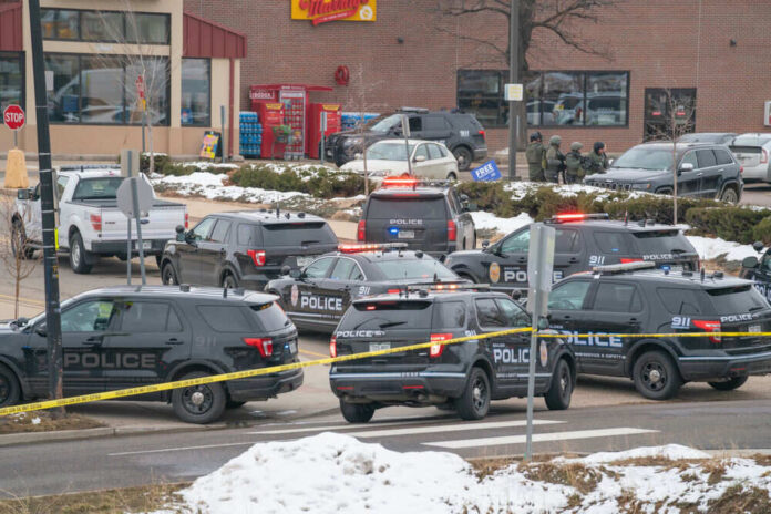 Police vehicles with flashing lights at scene snowy area
