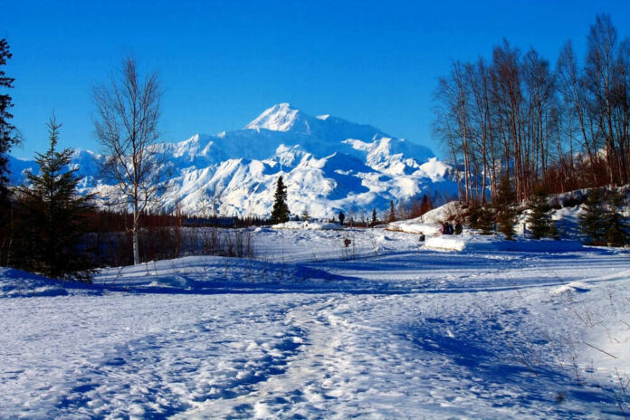 Snowy mountain landscape with clear blue sky