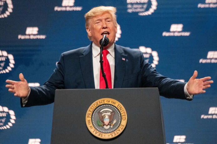 Man speaking behind podium at event with microphone