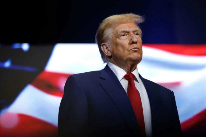 Man in suit with American flag background