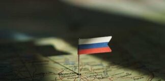 A small Russian flag pinned on a map