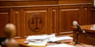 Courtroom desk with papers and microphone visible