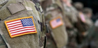 Soldiers in camouflage uniforms with American flag patches