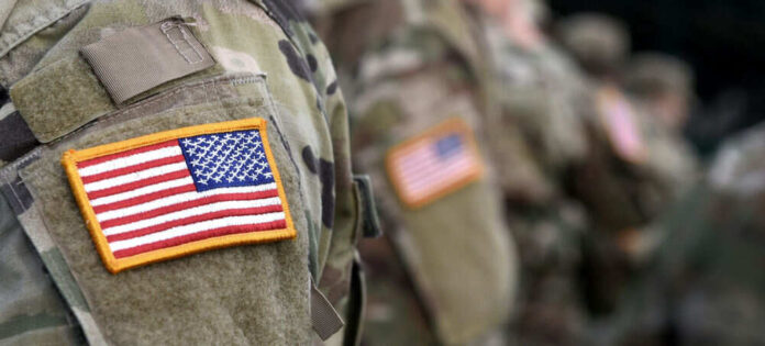 Soldiers in camouflage uniforms with American flag patches