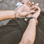 BRUTAL Attack on Grandma EXPOSES Seattle Scandal Person handcuffed lying on the ground outdoors