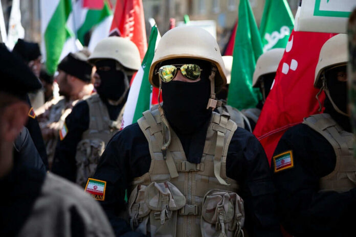 Soldiers in formation with flags and helmets visible