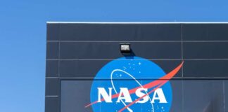 NASA logo displayed on a building against a clear blue sky