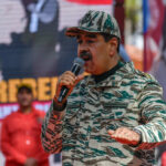 MADURO PERP WALK Shocks the World Man in camouflage uniform speaking at event outdoors