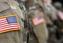 Soldiers in camouflage uniforms with American flag patches