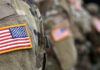 Soldiers in camouflage uniforms with American flag patches