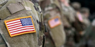 Soldiers in camouflage uniforms with American flag patches